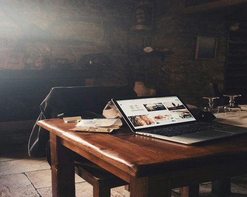 person working comfortably on a laptop at home in Italy