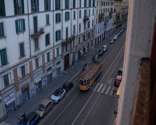 calm reading place near a window showing Italian city street outside